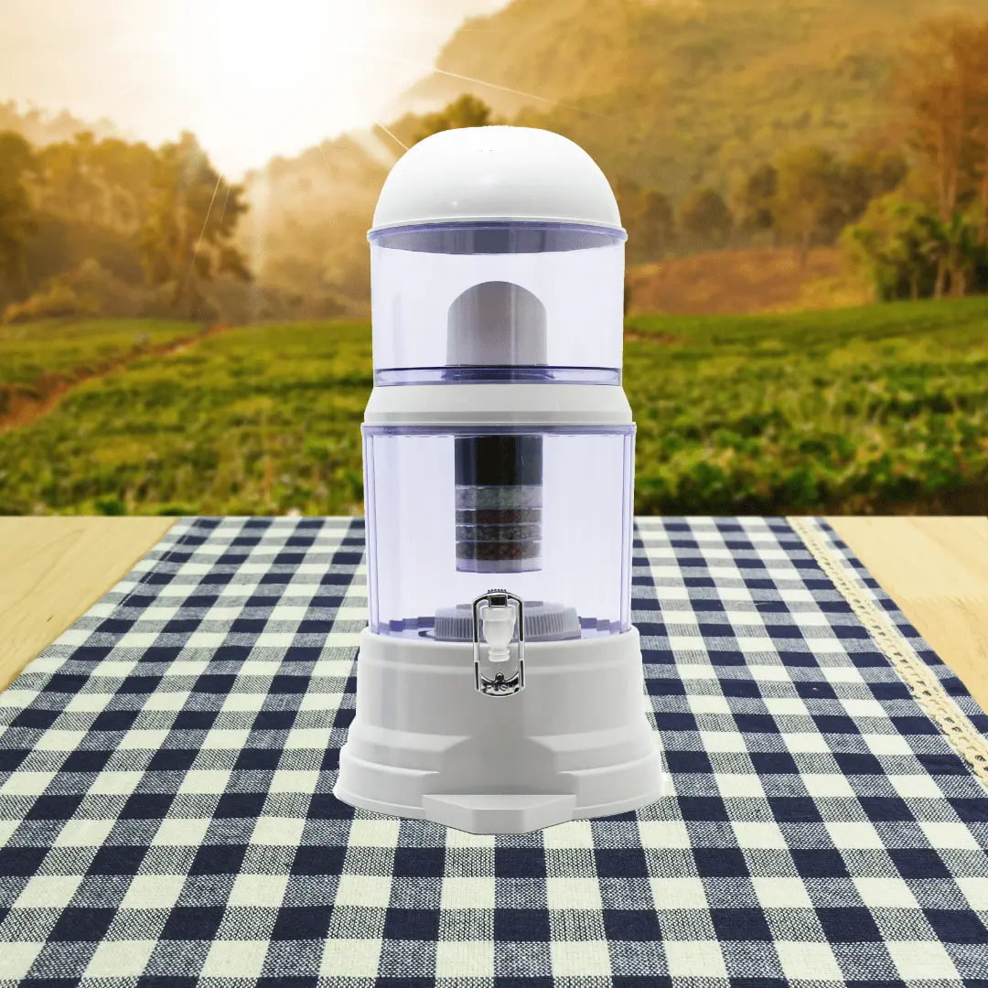 SUPERPURE 14L Water Dispenser with Filters &amp; Mineral Pot Open Box Deal on a checkered tablecloth with a lush green landscape in the background, showcasing an affordable option for clean drinking water at home.